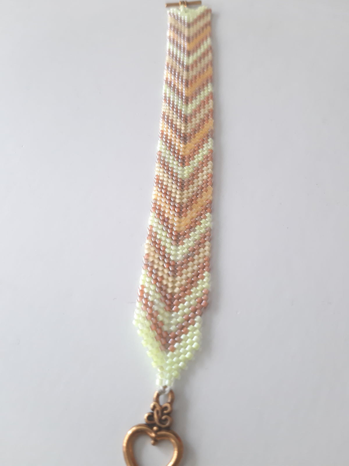 Chevron weave seed bead bracelet in blush and ivory tones with heart toggle clasp